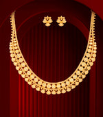 Gold necklace and earrings on a red background