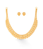 Gold necklace and earrings set on a white background