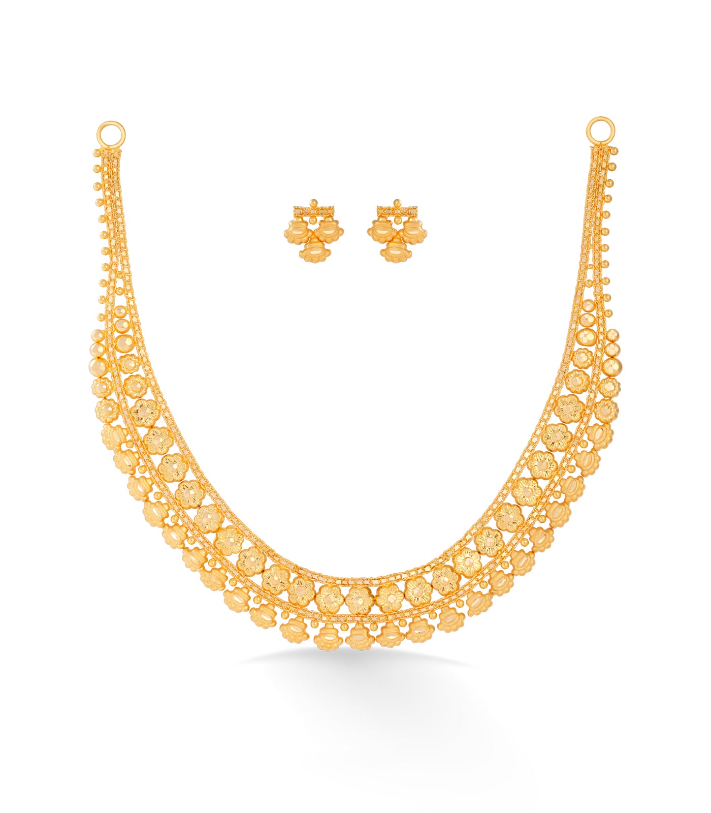 Gold necklace and earrings set on a white background