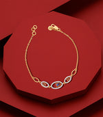 Gold bracelet with unique design elements on a red background